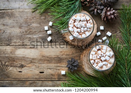 Cocoa with marshmallows in glass mugs on a wooden background                              