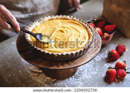 Woman making lemon meringue tart