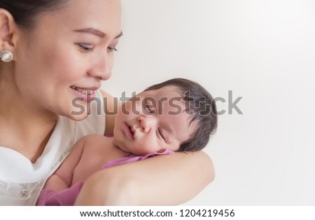 Close up portrait of beautiful young asian mother with her newborn baby copy space. Healthcare and medical family love lifestyle nursery motherâ€™s day concept