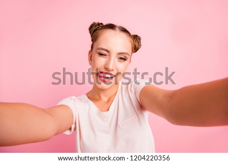 Carefree concept. Close up portrait of  funky, enjoy, glad, rejoice youngster lady make selfie on front camera of modern telephone or cellular phone isolated on bright pink background