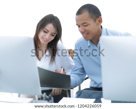 employees discussing financial documents sitting at a Desk