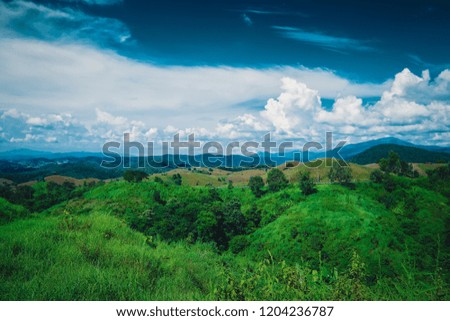 View of tropical forest at the top of the mountain. hillside in the countryside with cloud and blue sky background. Scenic view of natural attractions for tourists.