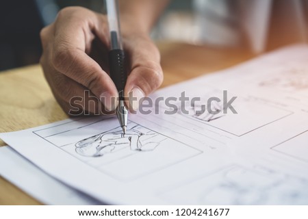 Storyboard or storytelling drawing creative for movie process pre-production media films script for video editors, Student hand writing graphic organizer in form of illustrations displayed in sequence Royalty-Free Stock Photo #1204241677