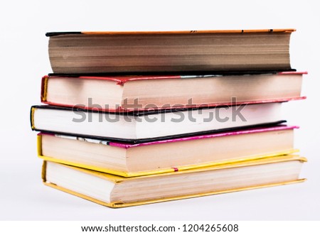 books pile on the table to read