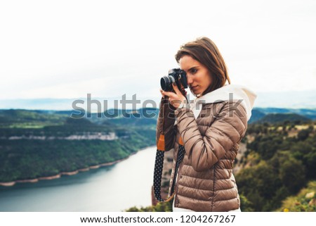 photographer traveler on top on mountain, tourist looking hold in hands digital photo camera, hiker taking click photography, girl enjoy nature panoramic landscape in trip, relax holiday hobby concept