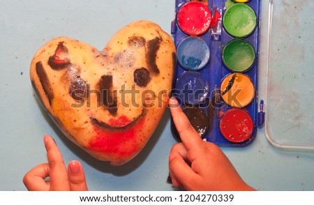 potato face painted with watercolors. Kids' games. Tubercle with heart shape. Pictorial manuals.