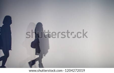 diffused silhouette of people through white cloth