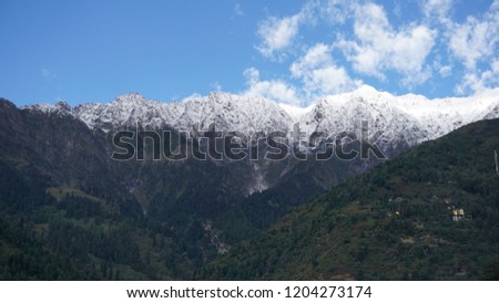 Snow-capped mountains from Kullu Valley, Manali, Himachal Pradesh, India. The picture can be used for backgrounds and postcards for someone who loves mountains.