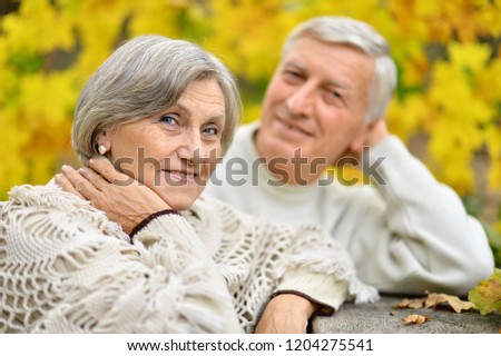 Portrait of elderly couple at table in forest