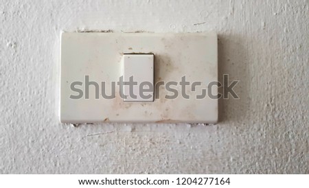 old white light switch wall white cement
