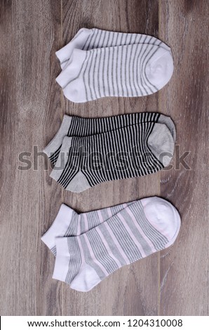 Short clean knitted socks on wooden background. Selective focus.