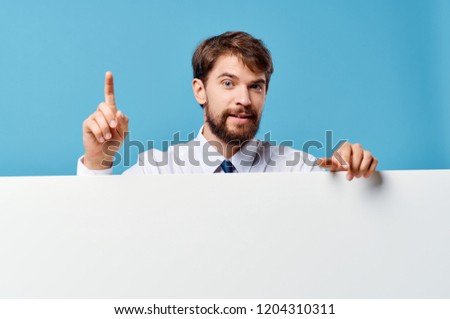 man behind white layout on blue background                           