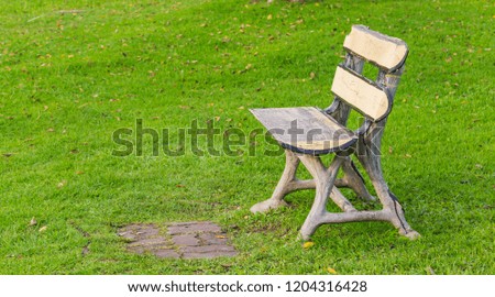chair with no people sitting on a lawn in a park. A place for exercise and relaxation.