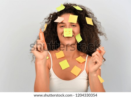 Pretty female with paper notes glued on her head and body. isolated