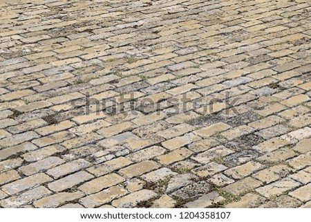 Texture. Pedestrian street in the city center lined with cobblestones
