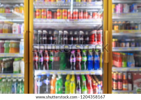 supermarket convenience store refrigerators with soft drink bottles on shelves abstract blur background Royalty-Free Stock Photo #1204358167