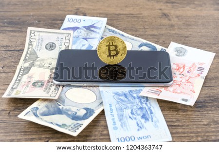 Businessman Shake hands on bitcoins and Banknotes dollars, money, won, yen. the form of digital. an intermediary in the exchange of goods and services. Image use for business concept.