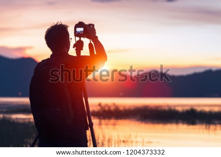 Silhouette of a photographer like to travel and photography