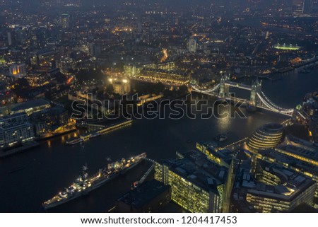 Night view of London Bridge and HMS Belfast on River Thames 