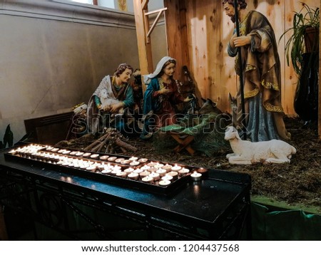 Sculptures of the Virgin Mary, St. Joseph, the shepherd and the sheep at the empty cradle in the Catholic Church. Waiting for Christmas, advent.
