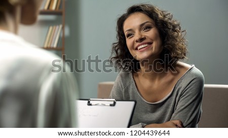 Young happy lady talking with psychologist at clinic, session of rehab therapy Royalty-Free Stock Photo #1204439644