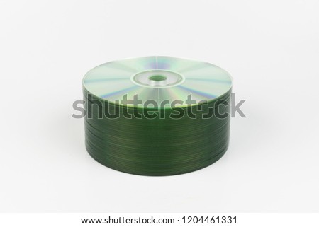 Neatly organized stack of CD or DVD media storage discs on a white background, with the shiny; prismatic recording surface up and creating multiple rainbows of colors.