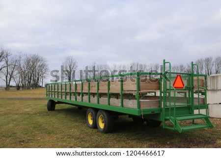 The green trailer is used a lot on this farm. Royalty-Free Stock Photo #1204466617