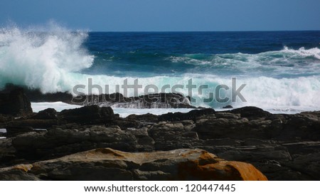 Huge waves breaking on the rocks.