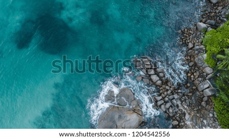 aerial photo of sea shore and mountains. ocean, waves and palms view