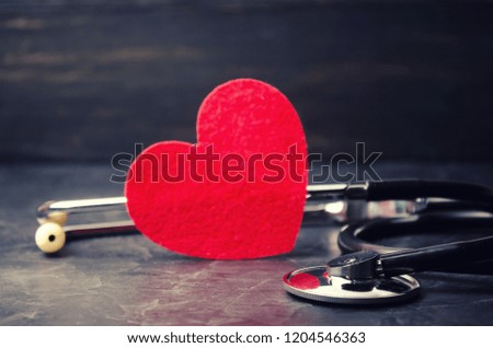 Red heart and stethoscope. The concept of medicine and health insurance, family, life. Ambulance. Cardiology Healthcare.