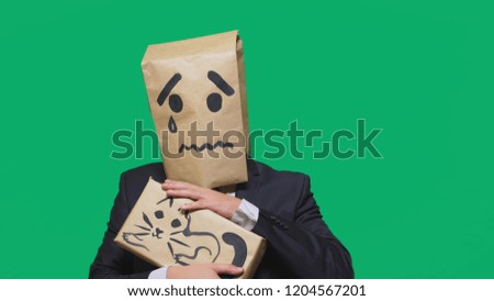 concept of emotion, gestures. a smile with a painted smiley crying, sad and stroking a cat. drawn on the box