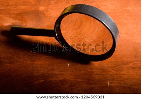 Magnifying glass on a wooden table for work