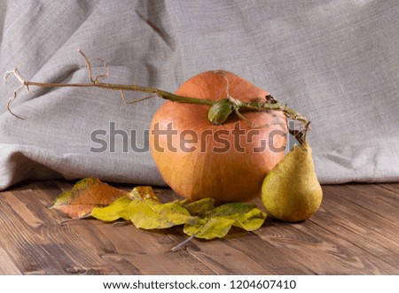 pumpkin and pear on a wooden board
