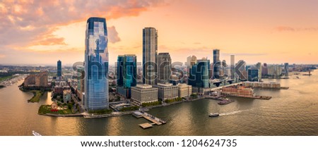 Aerial panorama of Jersey City skyline at sunset. Royalty-Free Stock Photo #1204624735