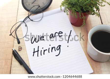 We Are Hiring, Motivational Business Recruitment Words Quotes Concept words letter, written on paper, work desk top view typography.  Royalty-Free Stock Photo #1204644688