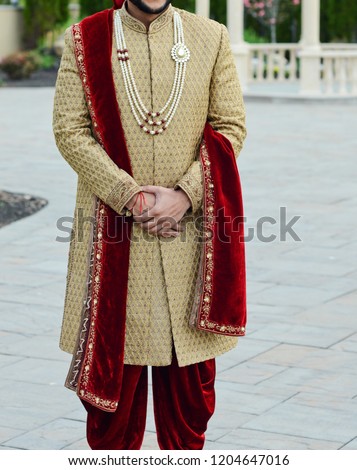 Indian groom wearing wedding sharwani dress  Royalty-Free Stock Photo #1204647016