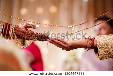 Indian Bride and groom holding hands and the mehndi design Royalty-Free Stock Photo #1204647838