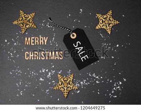 Merry Christmas black background and price label.  Black Friday. Sales concept. Copy space.  paper label against a dark grey background. Black Friday shopping sale concept with Black ticket Sale tag