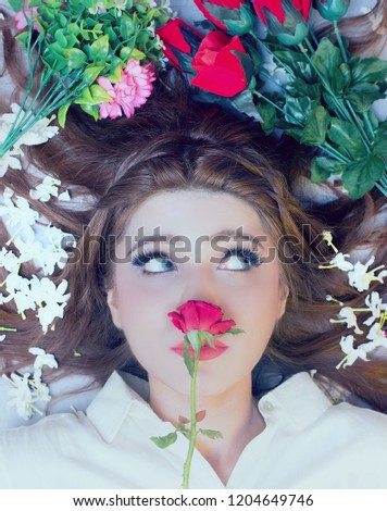 Beauty portrait shot with rose and colourful flowers. 
