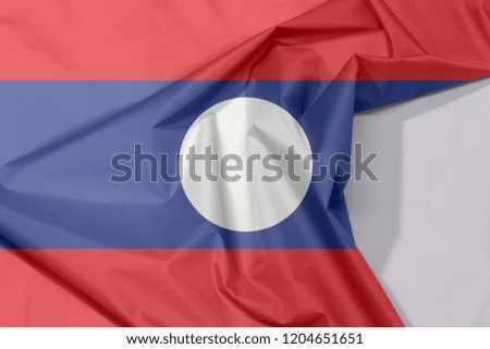 Laos fabric flag crepe and crease with white space, blue red and white circle color.