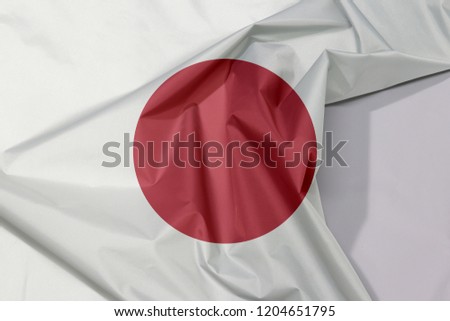 Japan fabric flag crepe and crease with white space, red circle sun on white. 