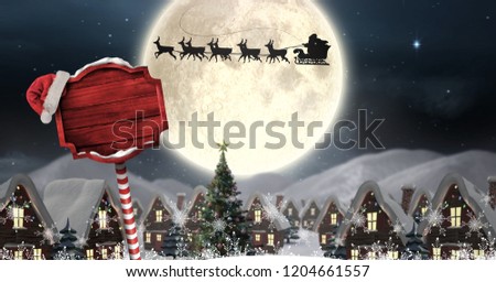 Digital composite of Santa in sleigh with reindeer flying and Christmas sign in Winter wonderland