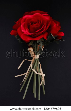 A studio photo of a bouquet of roses