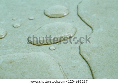 A macro photography of water splash and spot on the floor after rain.