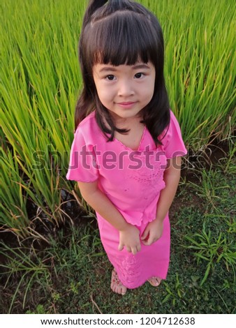Lovely girl in dress pink . Over green background. Love concept 