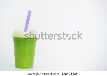 healthy green juice in takeaway cup with purple straw white background with room for quote or text social media wellness image