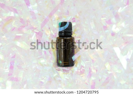 amber essential oil aromatherapy bottle on colorful festive background centred health wellness social media image with room for text or quote
