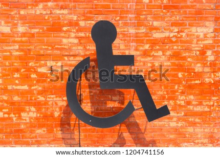 Wheelchair sign on brick wall toilet public