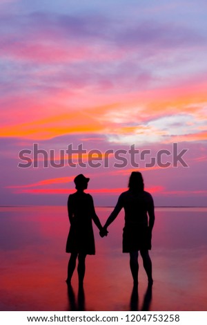 man and woman at sunset, seashore background,copy space