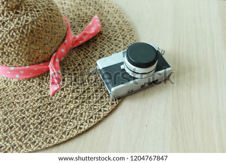 Accessories for travel Vintage Hat ,and camera glasses on the wooden desk. top view